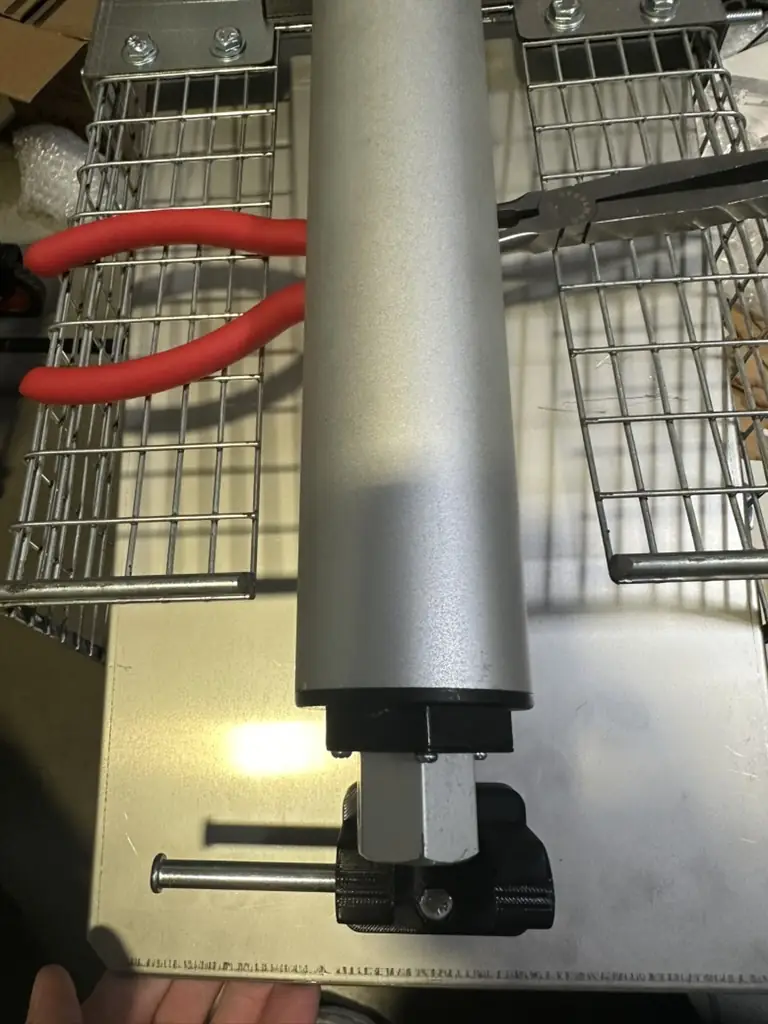 The motor propped up on pliers so it has room to extend