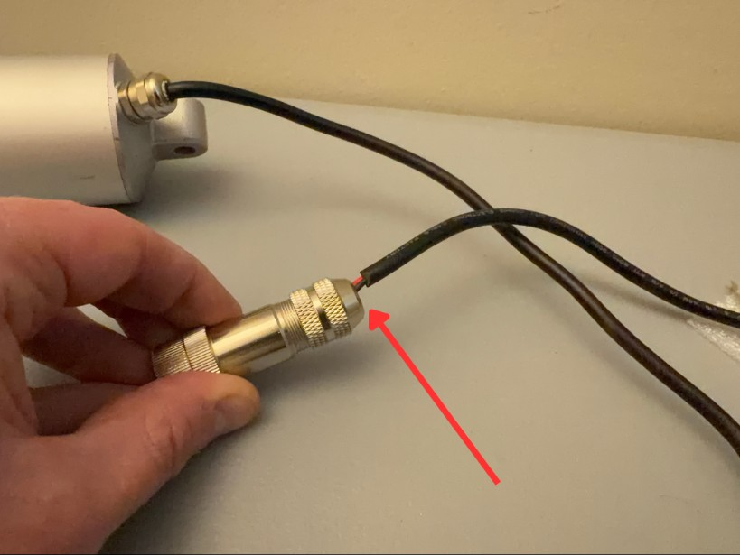 Exposed red and black internal wires at the motor cable connector